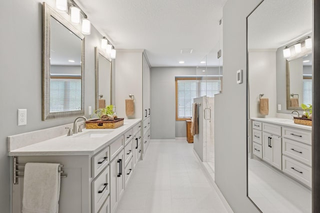 18172 Tamarack Dr, Minnetonka, MN 55345 - bathroom with vanity, a stall shower, plenty of natural light, a textured ceiling, and baseboards