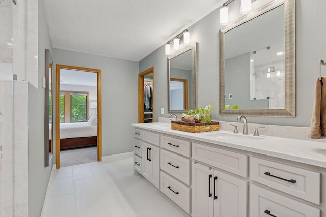 18172 Tamarack Dr, Minnetonka, MN 55345 - full bathroom with double vanity, a shower stall, ensuite bathroom, baseboards, and a textured ceiling