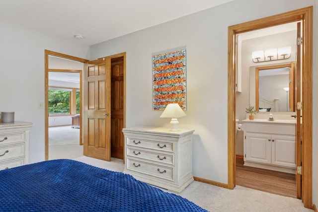 18172 Tamarack Dr, Minnetonka, MN 55345 - bedroom with light carpet, ensuite bathroom, and baseboards