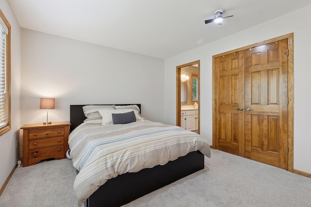 18172 Tamarack Dr, Minnetonka, MN 55345 - bedroom featuring light carpet, ensuite bathroom, a closet, and baseboards