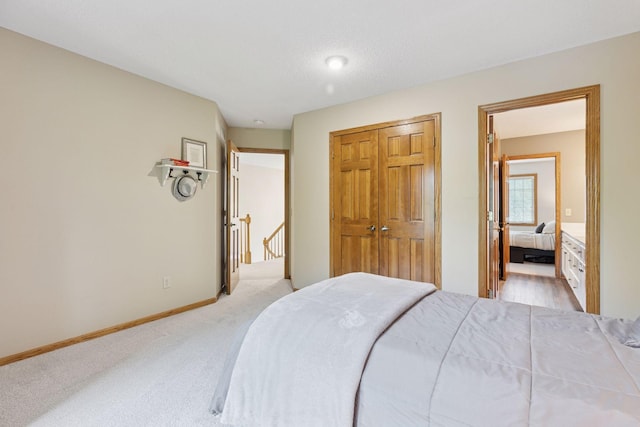 18172 Tamarack Dr, Minnetonka, MN 55345 - bedroom featuring light carpet, a closet, and baseboards
