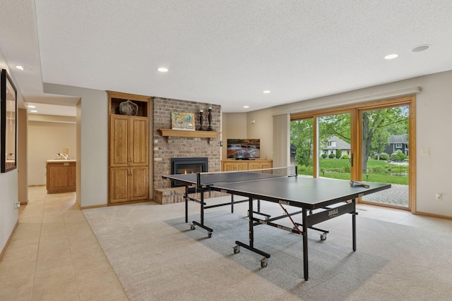 18172 Tamarack Dr, Minnetonka, MN 55345 - playroom with light tile patterned floors, a fireplace, light carpet, baseboards, and a textured ceiling
