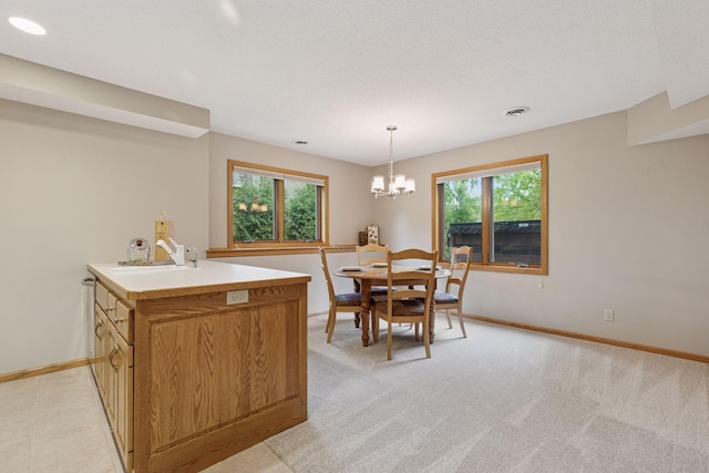 18172 Tamarack Dr, Minnetonka, MN 55345 - dining room with baseboards, a chandelier, and light colored carpet