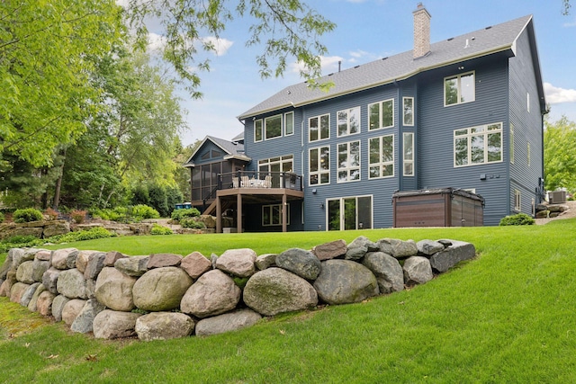 18172 Tamarack Dr, Minnetonka, MN 55345 - rear view of house featuring a sunroom, a chimney, cooling unit, a lawn, and a deck
