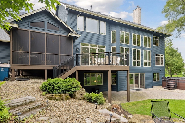 18172 Tamarack Dr, Minnetonka, MN 55345 - back of house featuring a sunroom, a patio, stairs, a chimney, and a wooden deck