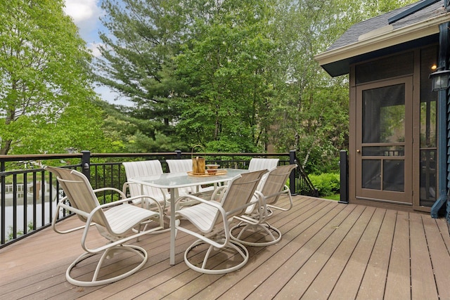 18172 Tamarack Dr, Minnetonka, MN 55345 - wooden deck with outdoor dining space and view of wooded area