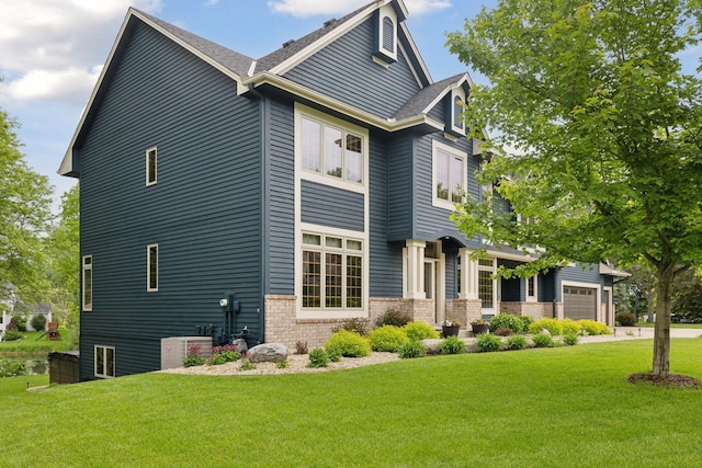 18172 Tamarack Dr, Minnetonka, MN 55345 - view of side of property featuring brick siding, a yard, and a garage