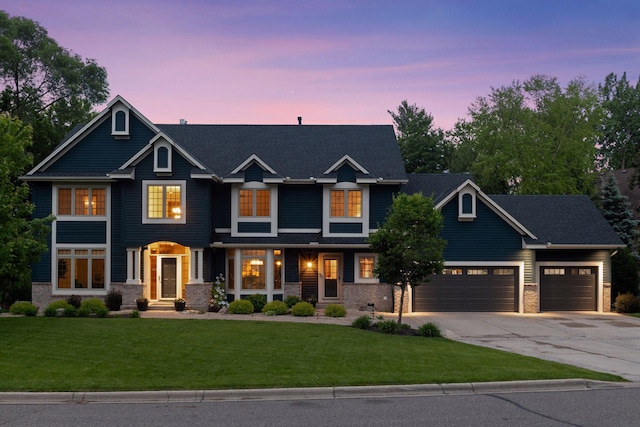 18172 Tamarack Dr, Minnetonka, MN 55345 - view of front facade with concrete driveway, a yard, a garage, and brick siding
