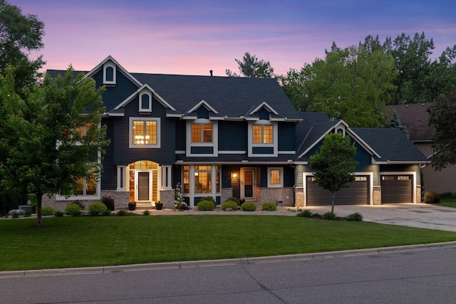 18172 Tamarack Dr, Minnetonka, MN 55345 - craftsman inspired home with driveway, an attached garage, a lawn, and brick siding
