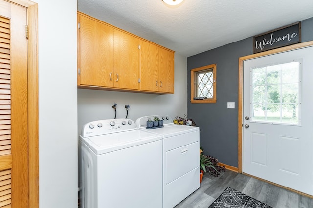311 Wisconsin St, Lake City, MN 55041 - laundry room with cabinet space, washing machine and dryer, wood finished floors, and a textured ceiling