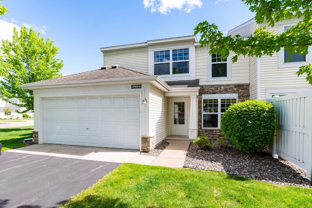 4960 149th St N Unit 6, Hugo, MN 55038 - view of front of house featuring stone siding, driveway, and an attached garage