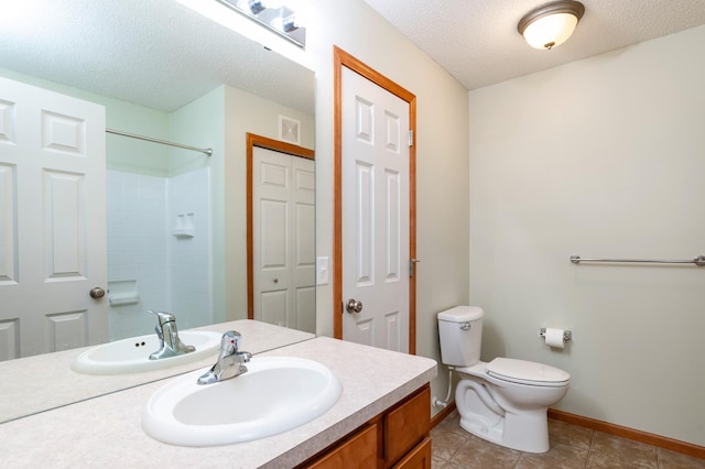 4960 149th St N Unit 6, Hugo, MN 55038 - bathroom featuring vanity, toilet, tile patterned flooring, a shower, and a textured ceiling