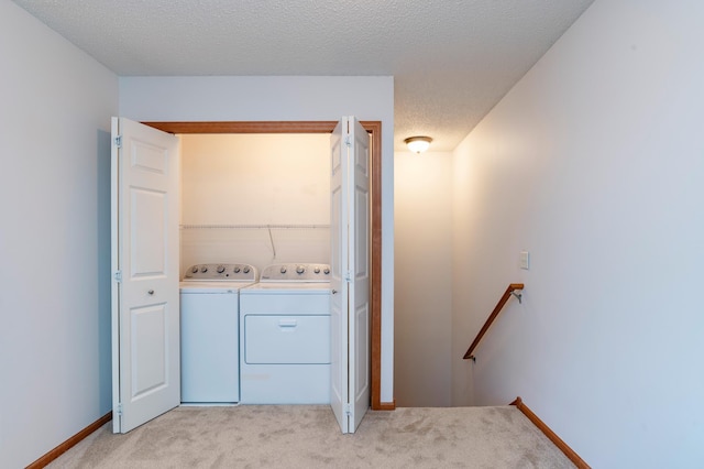 4960 149th St N Unit 6, Hugo, MN 55038 - laundry area with washer and dryer, light carpet, baseboards, and a textured ceiling