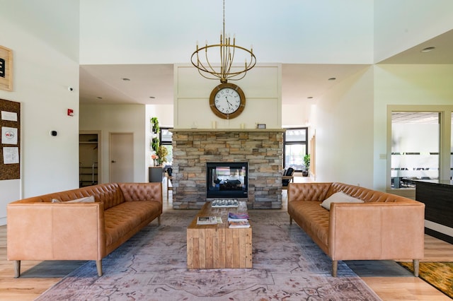 4960 149th St N Unit 6, Hugo, MN 55038 - living area with a stone fireplace, light wood-style floors, and a chandelier
