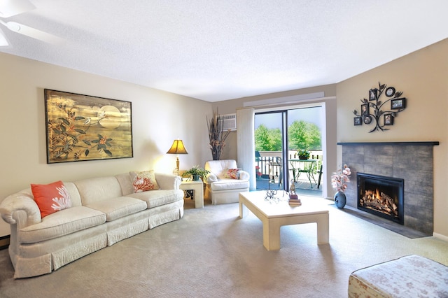 1825 Perlich Ave Unit 206, Red Wing, MN 55066 - carpeted living area featuring a tile fireplace, ceiling fan, and a textured ceiling