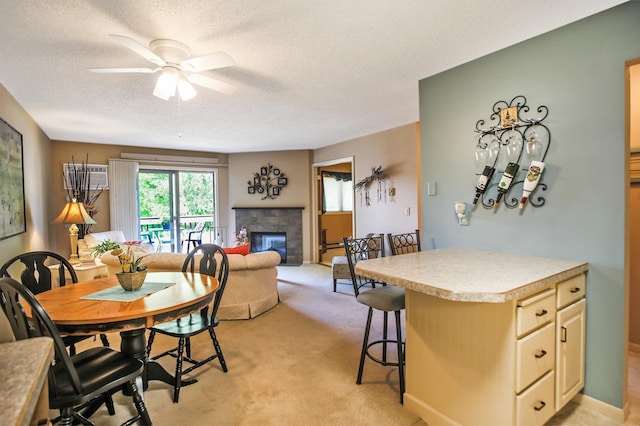 1825 Perlich Ave Unit 206, Red Wing, MN 55066 - dining area featuring ceiling fan, a glass covered fireplace, light colored carpet, and a textured ceiling