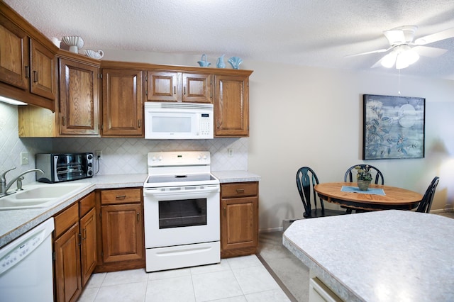 1825 Perlich Ave Unit 206, Red Wing, MN 55066 - kitchen with white appliances, a sink, brown cabinets, backsplash, and a textured ceiling