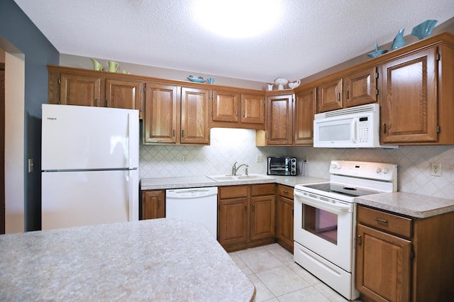 1825 Perlich Ave Unit 206, Red Wing, MN 55066 - kitchen with white appliances, a sink, light countertops, brown cabinets, and a textured ceiling