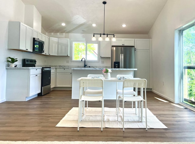 826 Sims Ave, Saint Paul, MN 55106 - kitchen with stainless steel appliances, a kitchen island, a sink, healthy amount of natural light, and recessed lighting