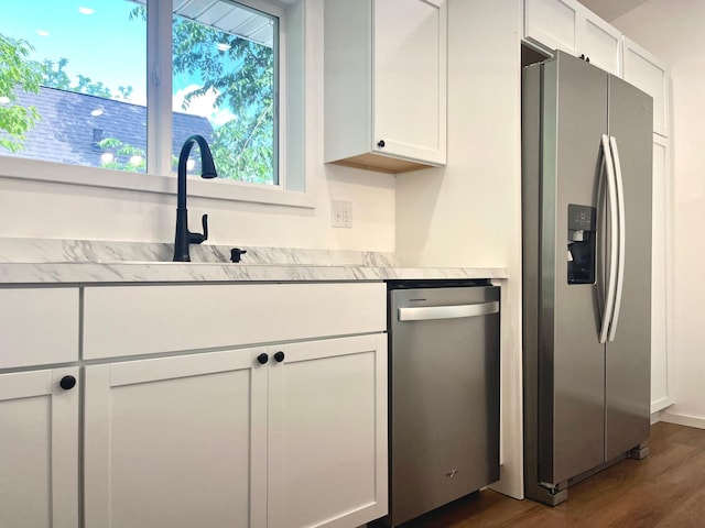 826 Sims Ave, Saint Paul, MN 55106 - kitchen with stainless steel appliances, dark wood-type flooring, light countertops, and white cabinetry