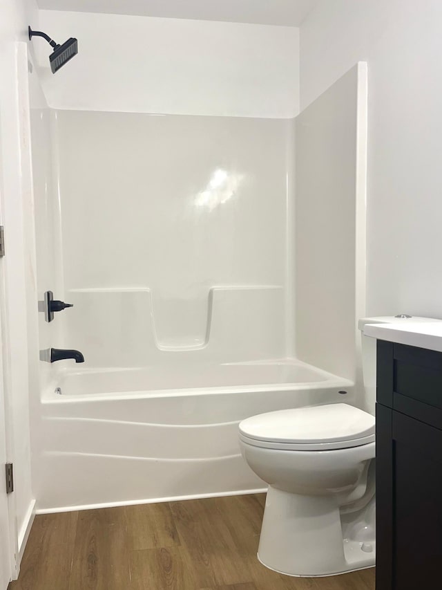 826 Sims Ave, Saint Paul, MN 55106 - bathroom with toilet, wood finished floors, vanity, and washtub / shower combination