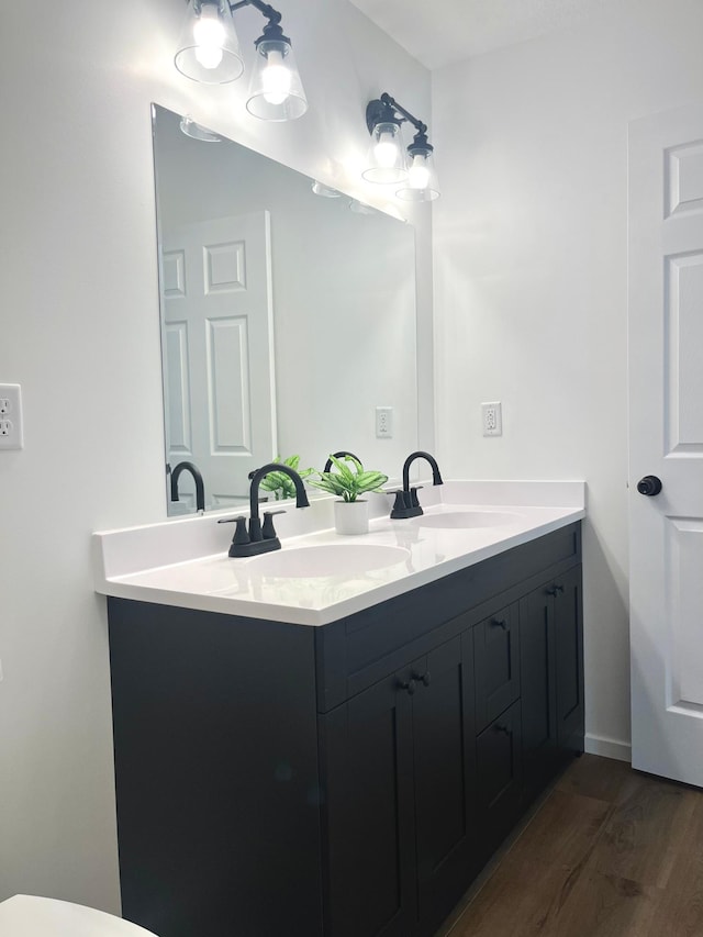826 Sims Ave, Saint Paul, MN 55106 - full bath featuring double vanity and wood finished floors
