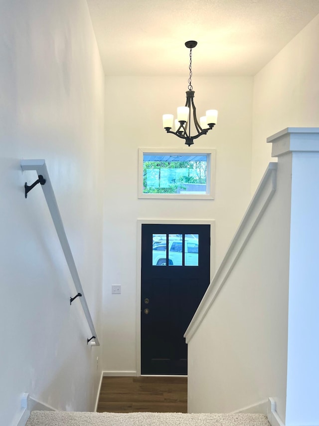 826 Sims Ave, Saint Paul, MN 55106 - foyer entrance with a chandelier, wood finished floors, and baseboards