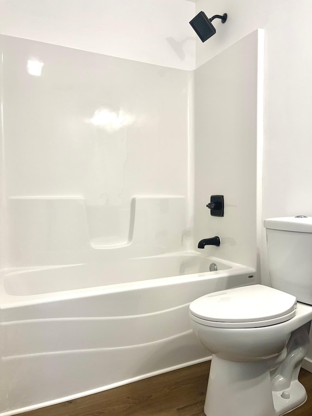 826 Sims Ave, Saint Paul, MN 55106 - bathroom with wood finished floors, toilet, and washtub / shower combination
