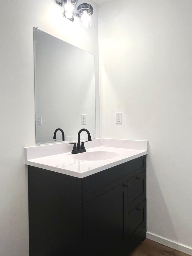 826 Sims Ave, Saint Paul, MN 55106 - bathroom with vanity and wood finished floors
