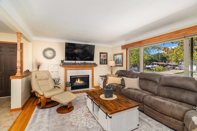 721 Maple Dr, Aurora, MN 55705 - living area featuring a fireplace, light wood-style flooring, and baseboards