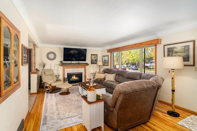 721 Maple Dr, Aurora, MN 55705 - living room featuring wood finished floors, a premium fireplace, and baseboards