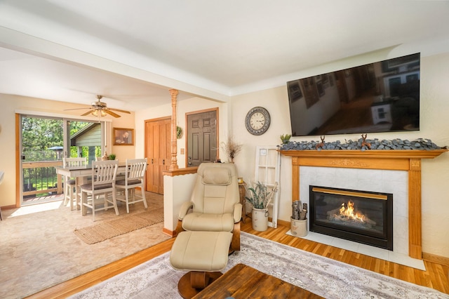 721 Maple Dr, Aurora, MN 55705 - living area with wood finished floors, ceiling fan, a fireplace, and baseboards