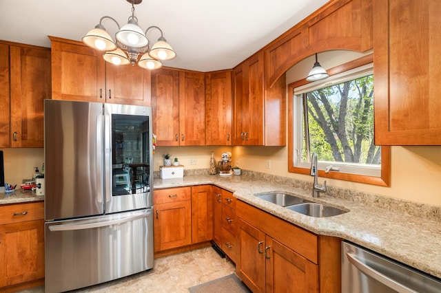 721 Maple Dr, Aurora, MN 55705 - kitchen featuring appliances with stainless steel finishes, a sink, brown cabinets, and light stone countertops