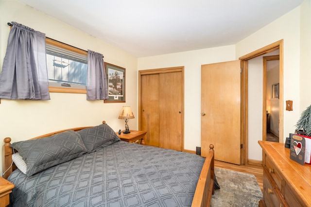 721 Maple Dr, Aurora, MN 55705 - bedroom with wood finished floors, a closet, and baseboards