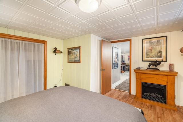 721 Maple Dr, Aurora, MN 55705 - bedroom featuring wood finished floors, a fireplace, an ornate ceiling, and baseboards