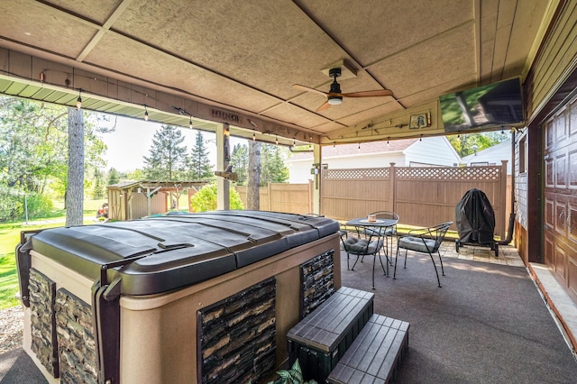 721 Maple Dr, Aurora, MN 55705 - view of patio / terrace with a hot tub, ceiling fan, outdoor dining area, and grilling area