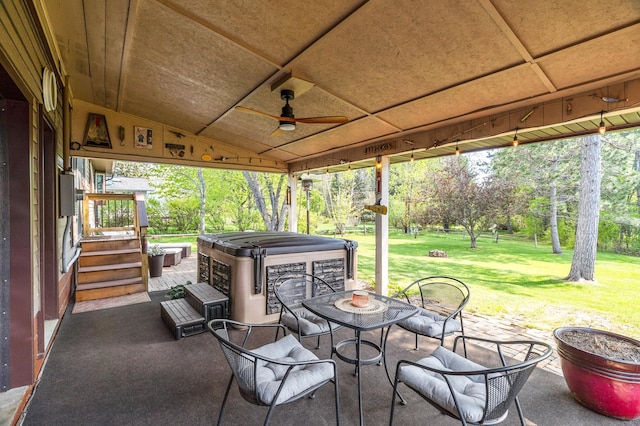 721 Maple Dr, Aurora, MN 55705 - view of patio / terrace with a hot tub, ceiling fan, and view of wooded area