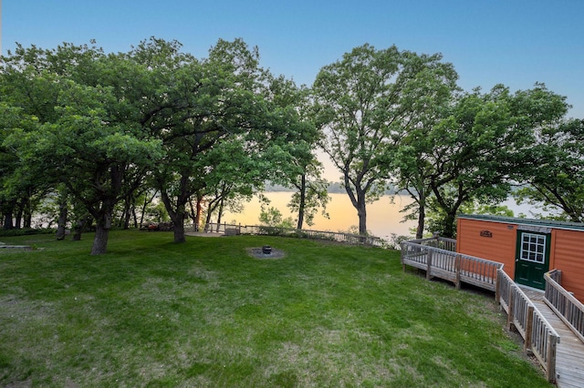 614 S Shore Dr S, Windom, MN 56101 - yard at dusk with a fire pit and a deck
