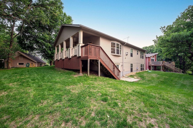 614 S Shore Dr S, Windom, MN 56101 - rear view of house featuring stairway, a yard, and a wooden deck