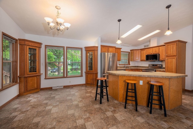614 S Shore Dr S, Windom, MN 56101 - kitchen featuring stainless steel appliances, vaulted ceiling, brown cabinets, a chandelier, and baseboards