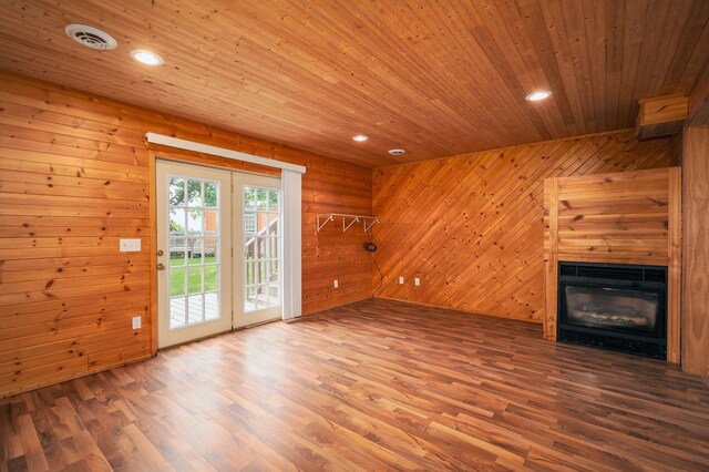 614 S Shore Dr S, Windom, MN 56101 - unfurnished living room featuring wood finished floors, wood ceiling, wood walls, a glass covered fireplace, and recessed lighting