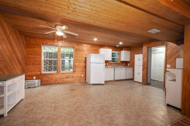 614 S Shore Dr S, Windom, MN 56101 - kitchen featuring freestanding refrigerator, light flooring, white cabinets, ceiling fan, and wooden walls