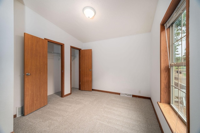 614 S Shore Dr S, Windom, MN 56101 - unfurnished bedroom featuring light colored carpet and vaulted ceiling
