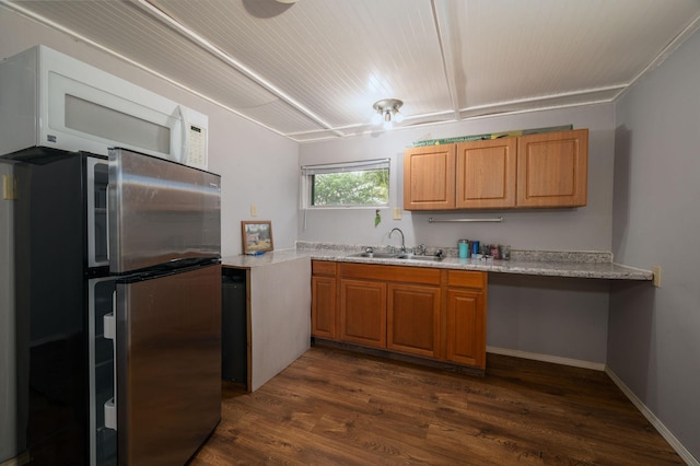 614 S Shore Dr S, Windom, MN 56101 - kitchen featuring freestanding refrigerator, a sink, light countertops, dark wood-style floors, and brown cabinets
