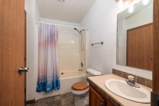 614 S Shore Dr S, Windom, MN 56101 - bathroom with vanity, toilet, shower / tub combo, and stone finish flooring