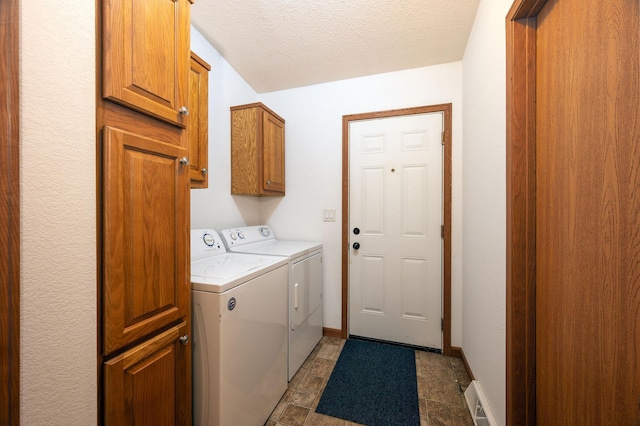 614 S Shore Dr S, Windom, MN 56101 - laundry room featuring separate washer and dryer, cabinet space, baseboards, and a textured ceiling