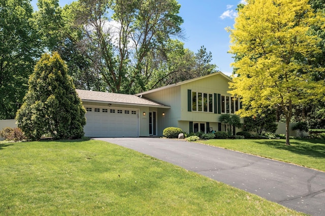 17915 17th Ave N, Plymouth, MN 55447 - split level home featuring a garage, asphalt driveway, and a front yard