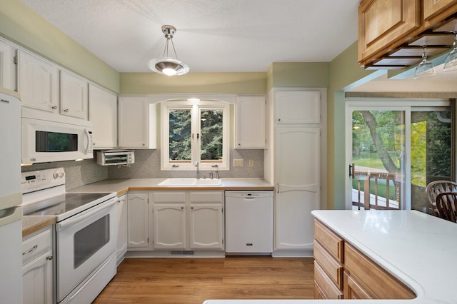 17915 17th Ave N, Plymouth, MN 55447 - kitchen featuring white appliances, a sink, arched walkways, tasteful backsplash, and plenty of natural light