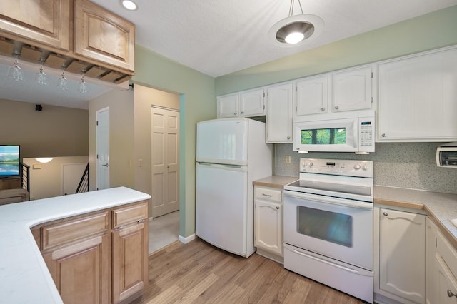 17915 17th Ave N, Plymouth, MN 55447 - kitchen with white appliances, light countertops, light wood-style floors, white cabinetry, and backsplash