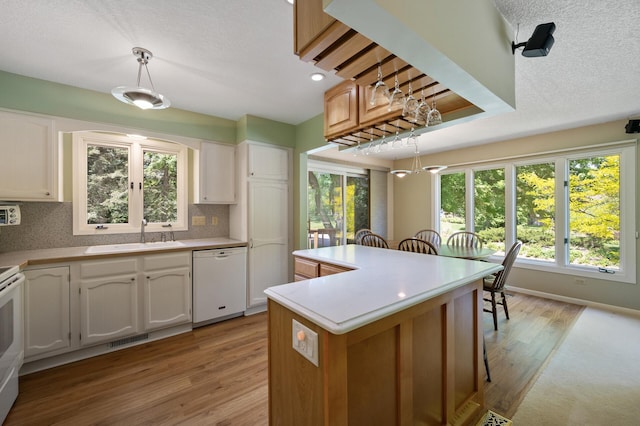 17915 17th Ave N, Plymouth, MN 55447 - kitchen featuring white appliances, a sink, light wood finished floors, healthy amount of natural light, and recessed lighting